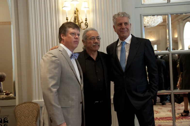 three older men are posing for the camera