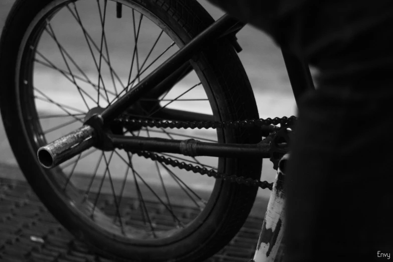 a person standing next to a bicycle on the side of a road