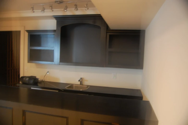 this kitchen has many cabinets and a stove