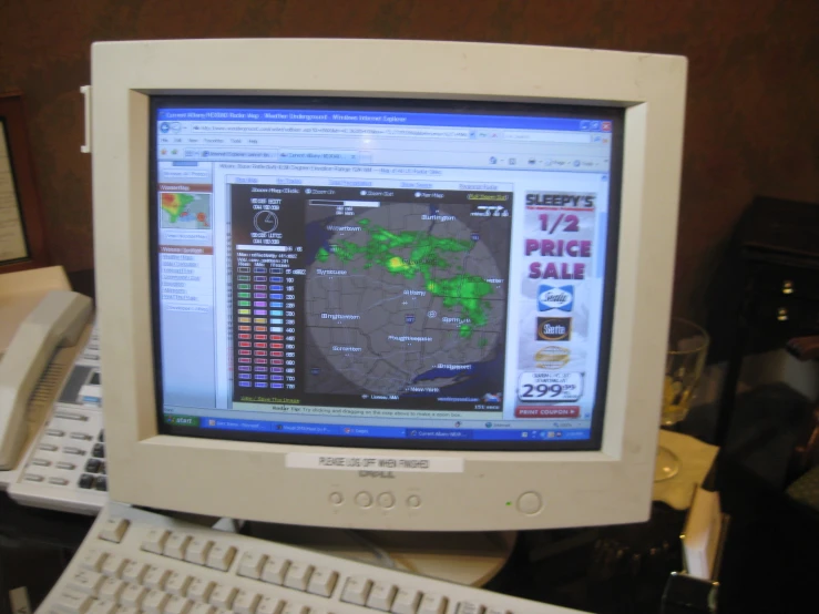 a computer monitor with weather information displayed on it