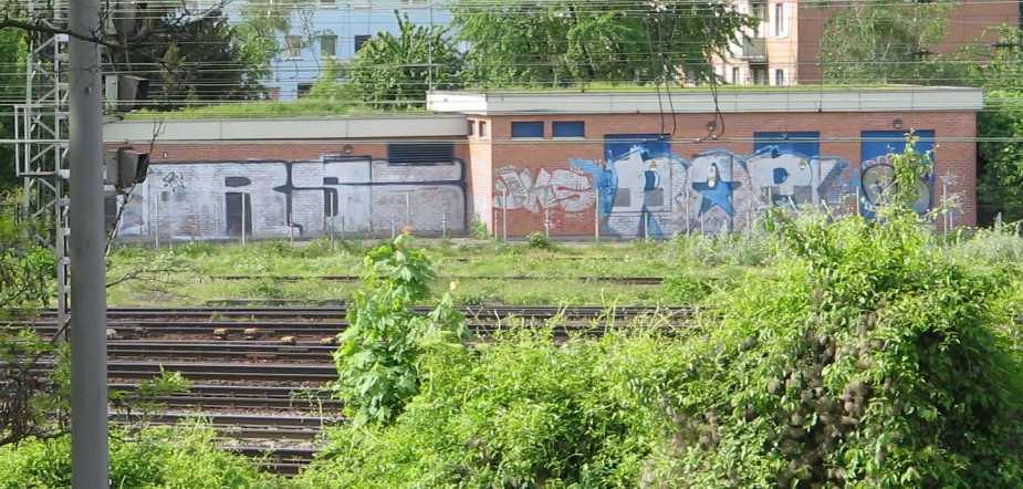 an abandoned train station with graffiti on the side