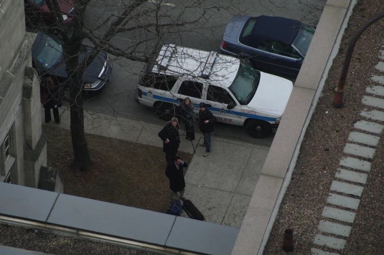 some police officers standing by a truck outside