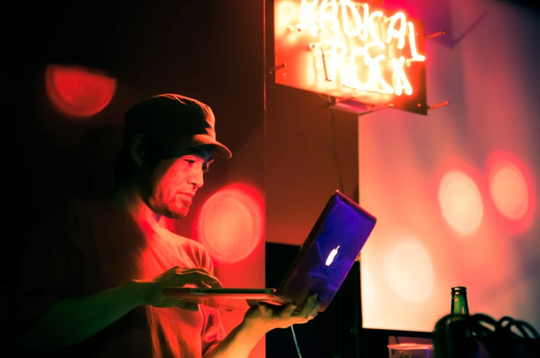 a man sitting at a laptop computer on his lap