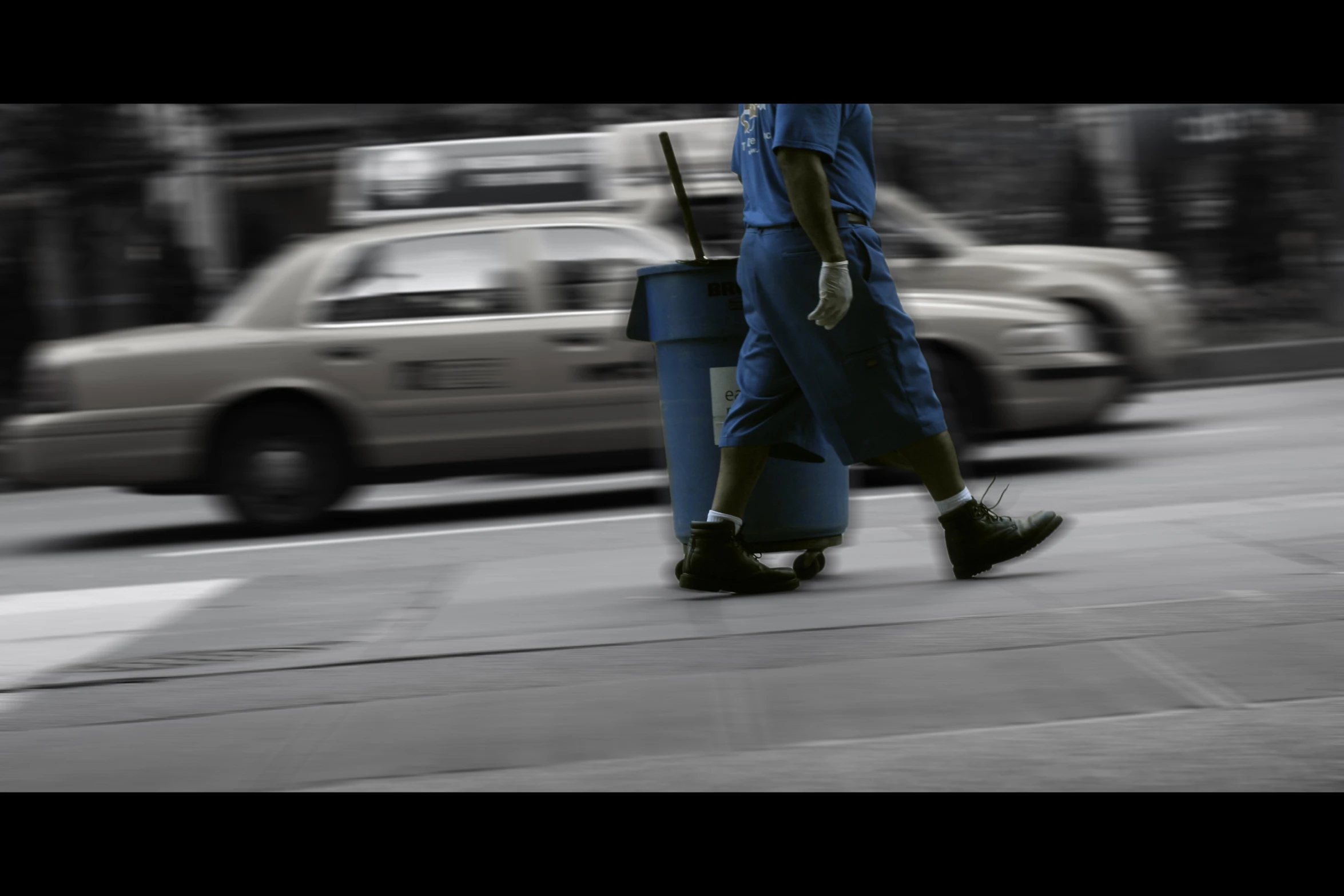 the man is walking down the road with his luggage