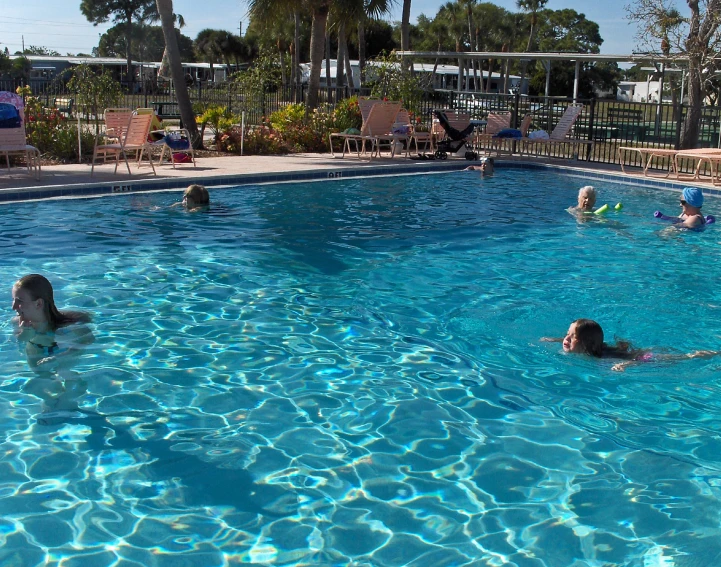 children in a swimming pool playing with toys