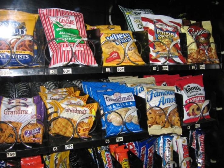 an assortment of snacks are lined up in a display