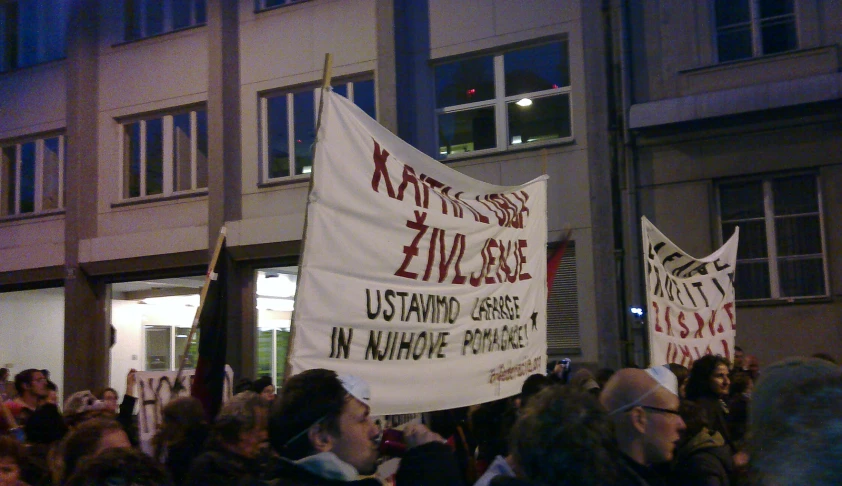 a group of people marching and holding signs