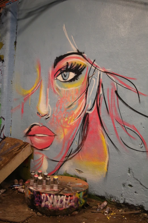 an image of a woman face painted on the side of a wall