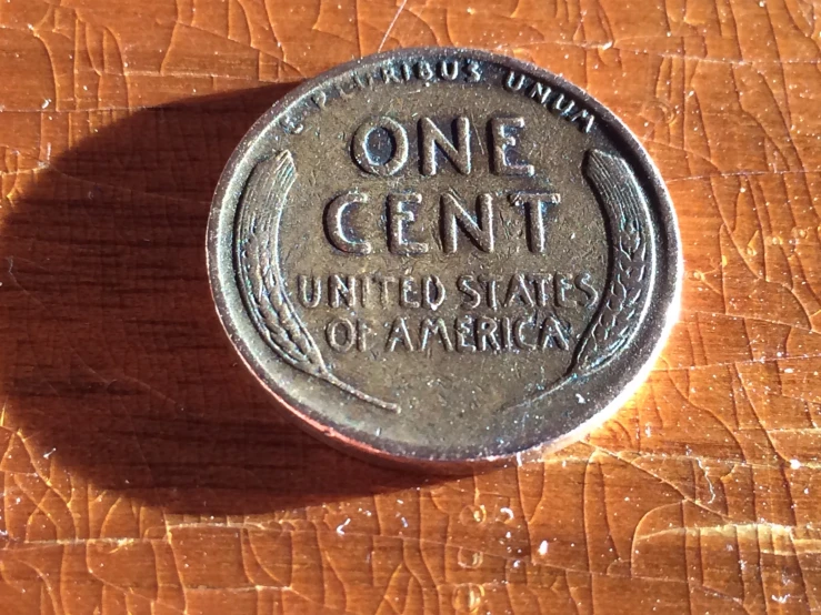 a coin sitting on top of a wooden table