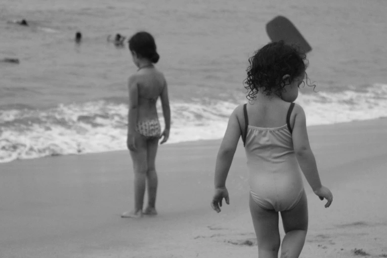 two s playing in the surf on the beach