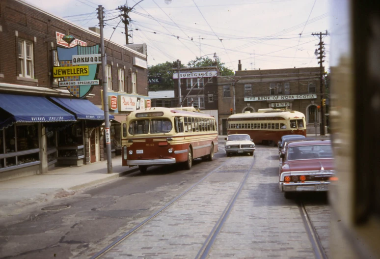 two trolleys passing each other on a city street