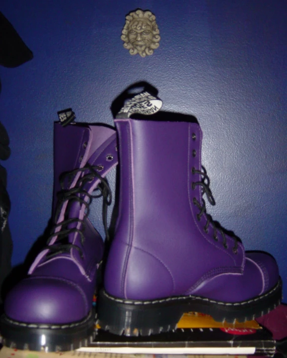 purple shoes are sitting in a cabinet in a room