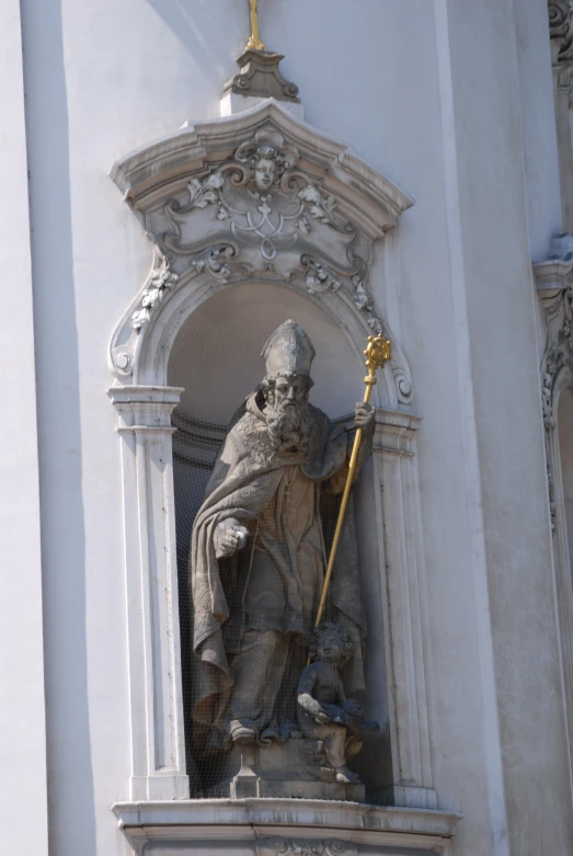 a statue that has a sceptula on its side