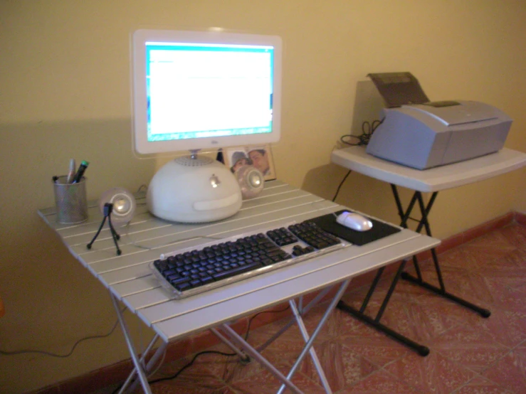 a desk with a computer and other office supplies