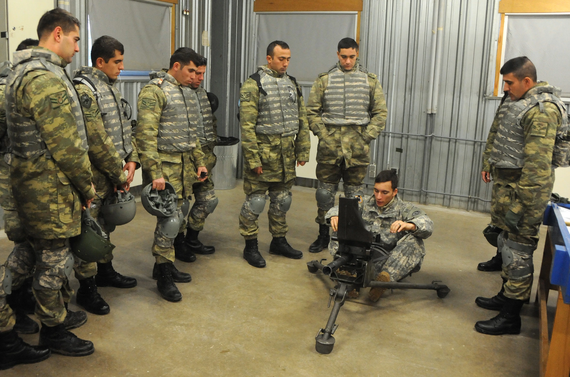 a man is sitting on the ground with soldiers