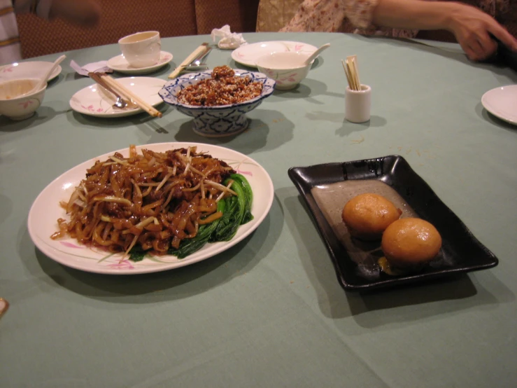 a table with plates full of various types of food