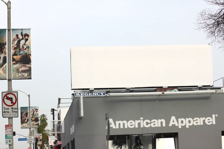 a person walking past american apparel on a street corner