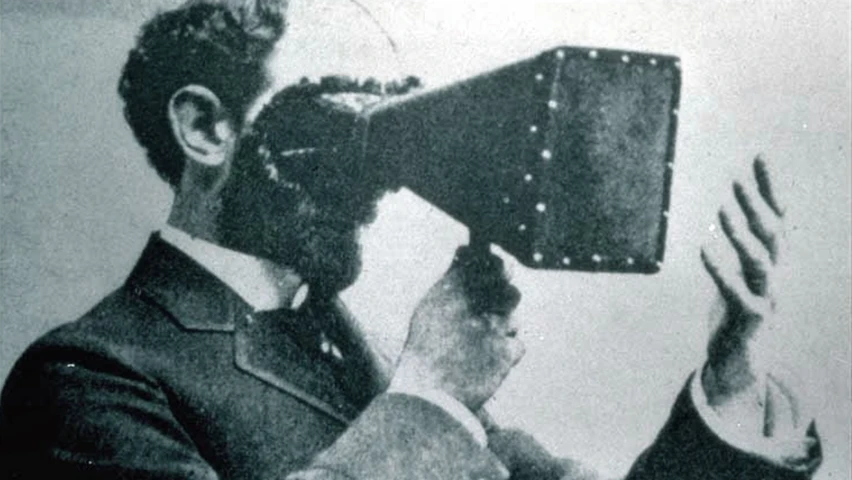 a man holding up a large metal object