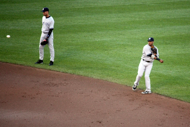 two baseball players standing on a baseball field