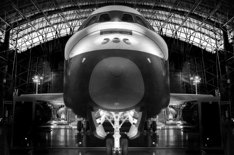 a space shuttle is parked inside an airplane hangar