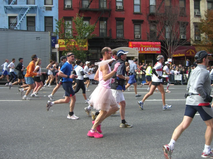 many people jogging down a city street