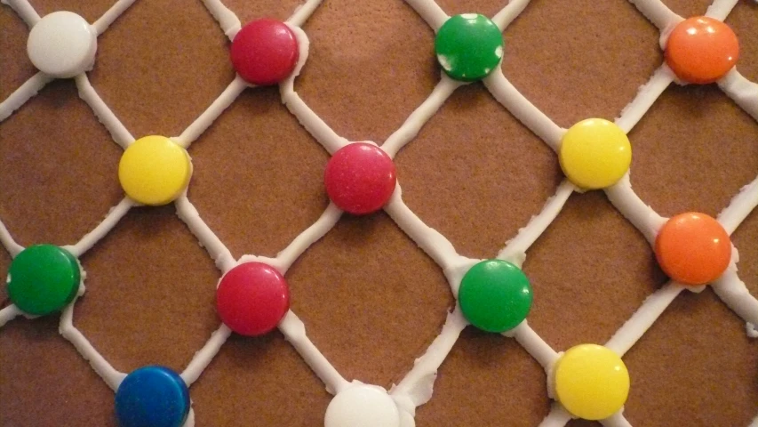 a stringed decorated wall holding some gumball ornaments