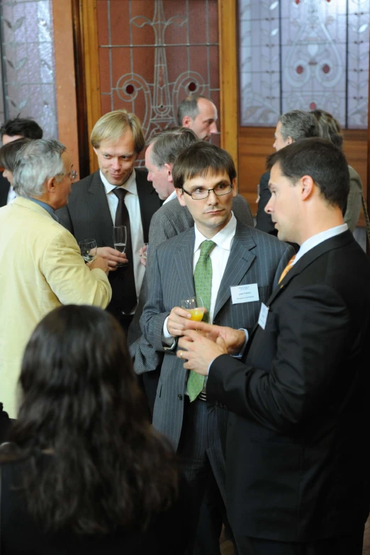 a group of business people having a conversation at an event