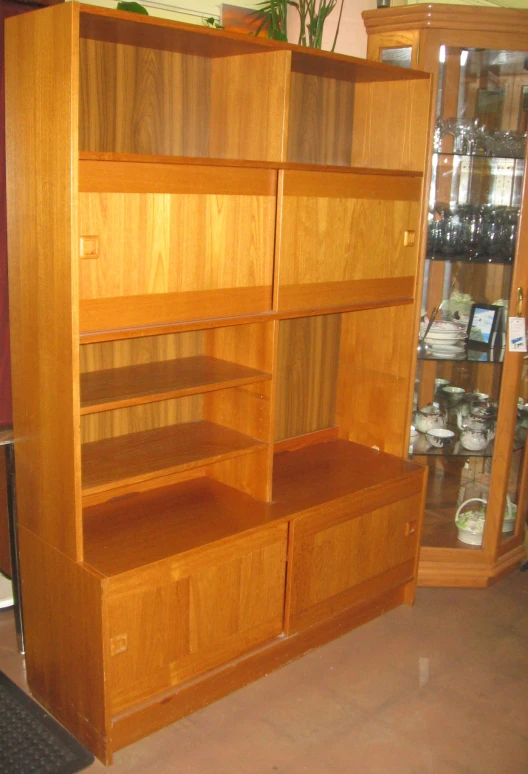 a wood book shelf with many drawers and shelves below it