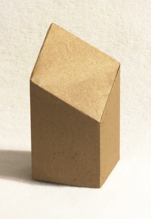 a closeup of an open brown box on a plain white surface