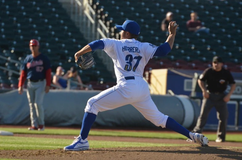 a pitcher on the field throwing a baseball