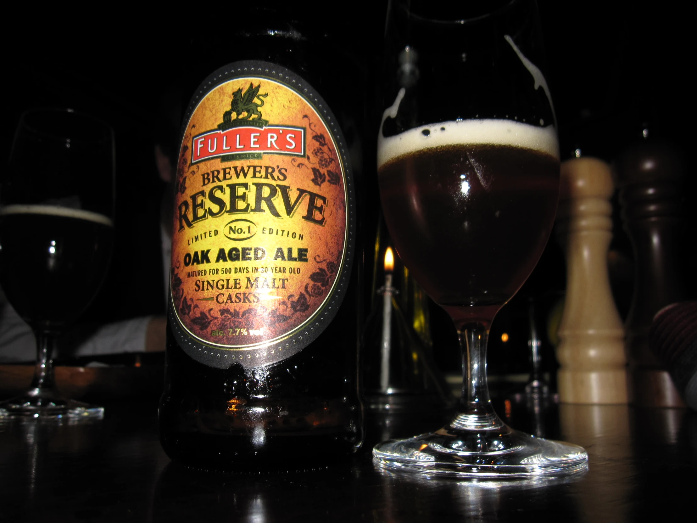 a glass and a bottle of beer on a table