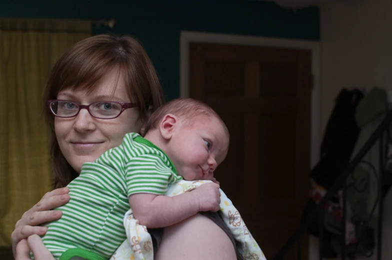 the woman is holding her new born baby in her arms