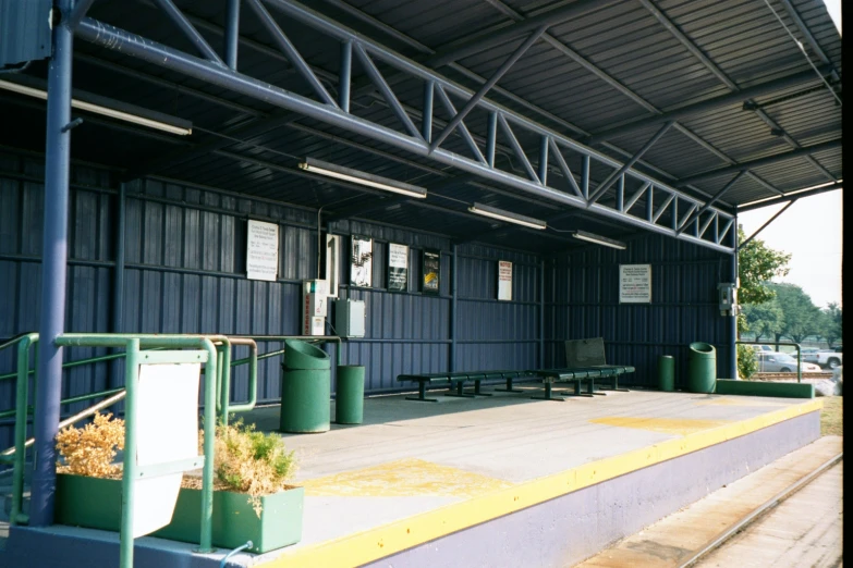 an empty green train station has no people at it