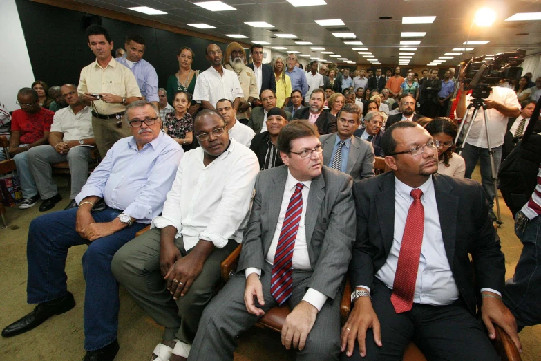 several people are sitting in chairs looking around