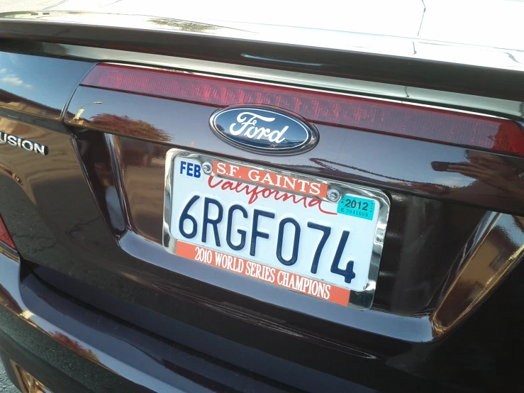 a close - up po of a black mustang with license plates