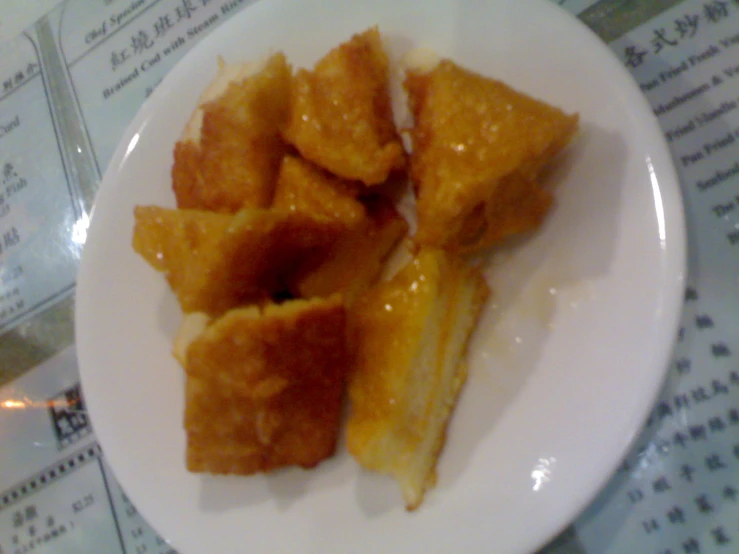 some fried food on a white plate on a table