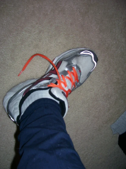 a person with shoes that are wearing bright colored laces