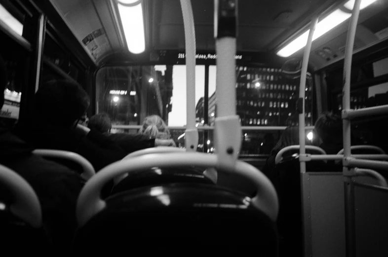 people sitting in a public transit bus at night