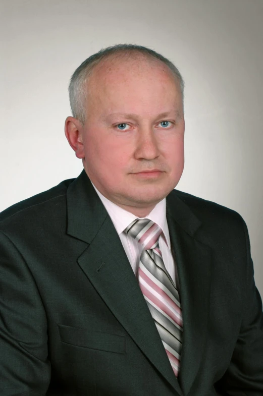 a man in suit sitting down with his arms crossed