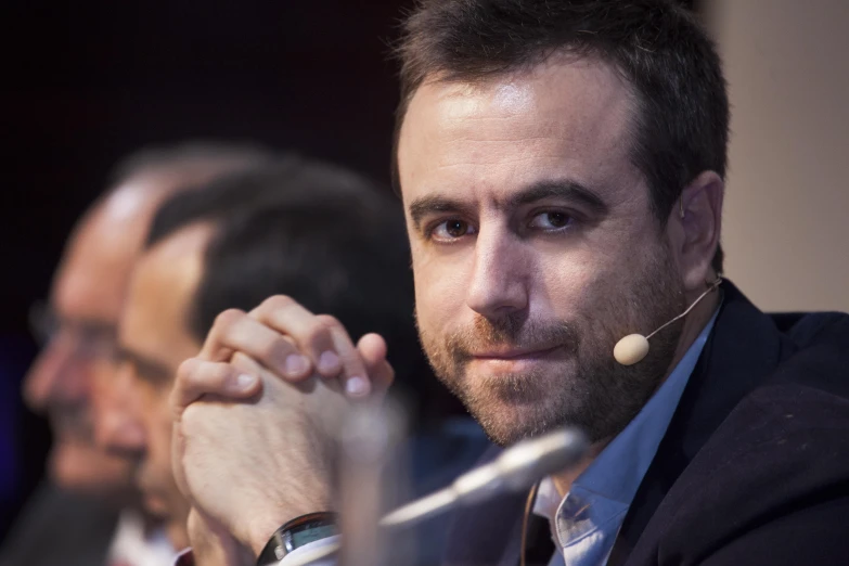 a man wearing a headset sitting at a table