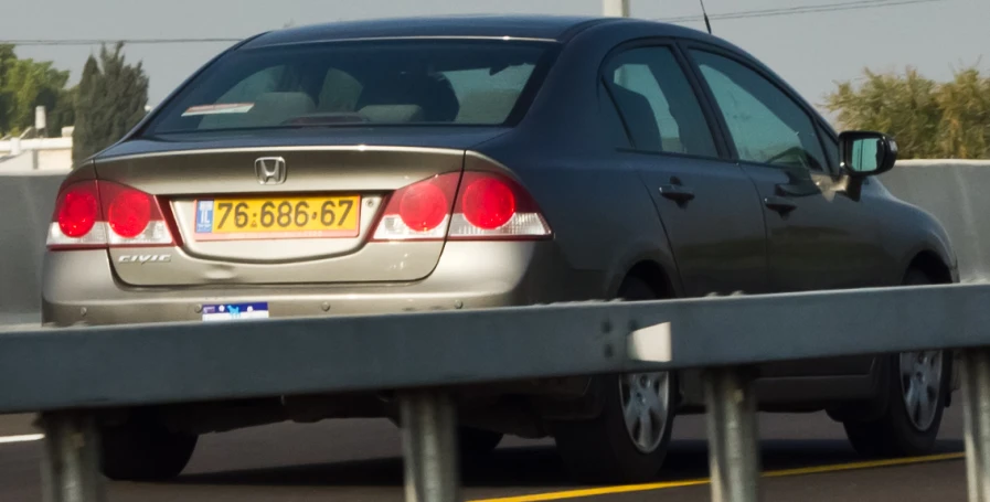 a car driving on a bridge over water