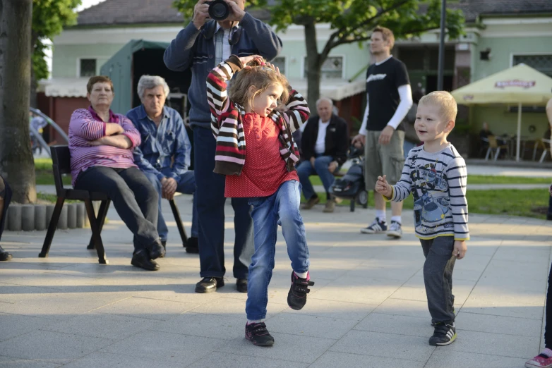 a man on a cell phone next to children