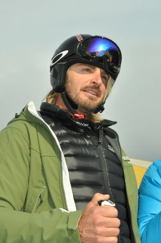 man wearing jacket and helmet in outdoor environment