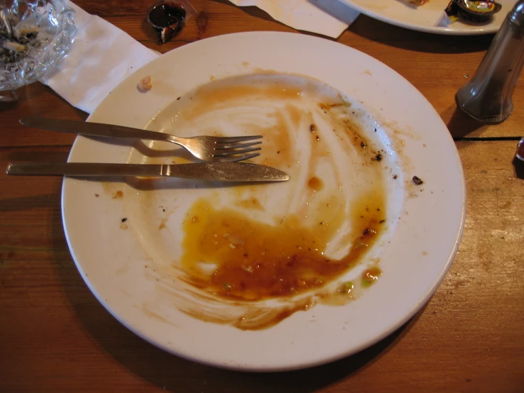 a plate that has been smothered and a silver fork on it