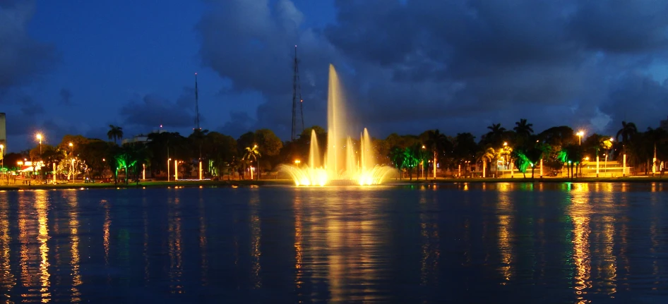 a pond is full of bright lights on a rainy evening