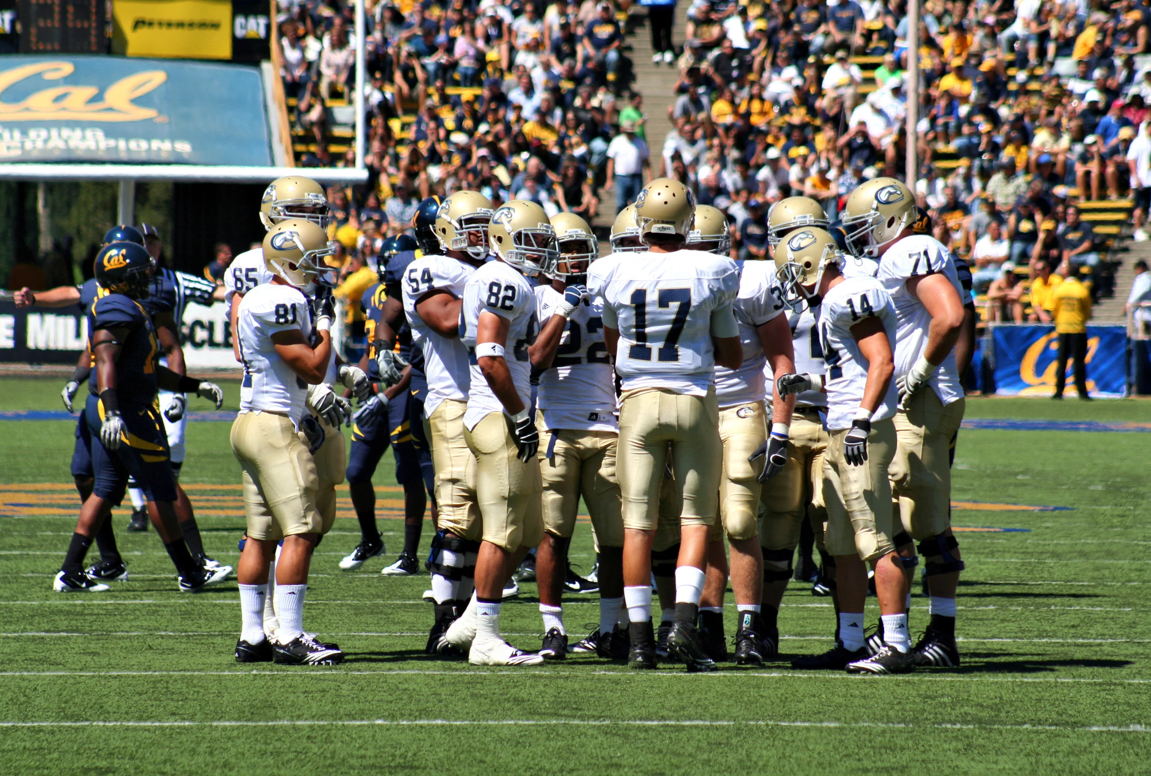 a group of men standing on top of a field next to each other