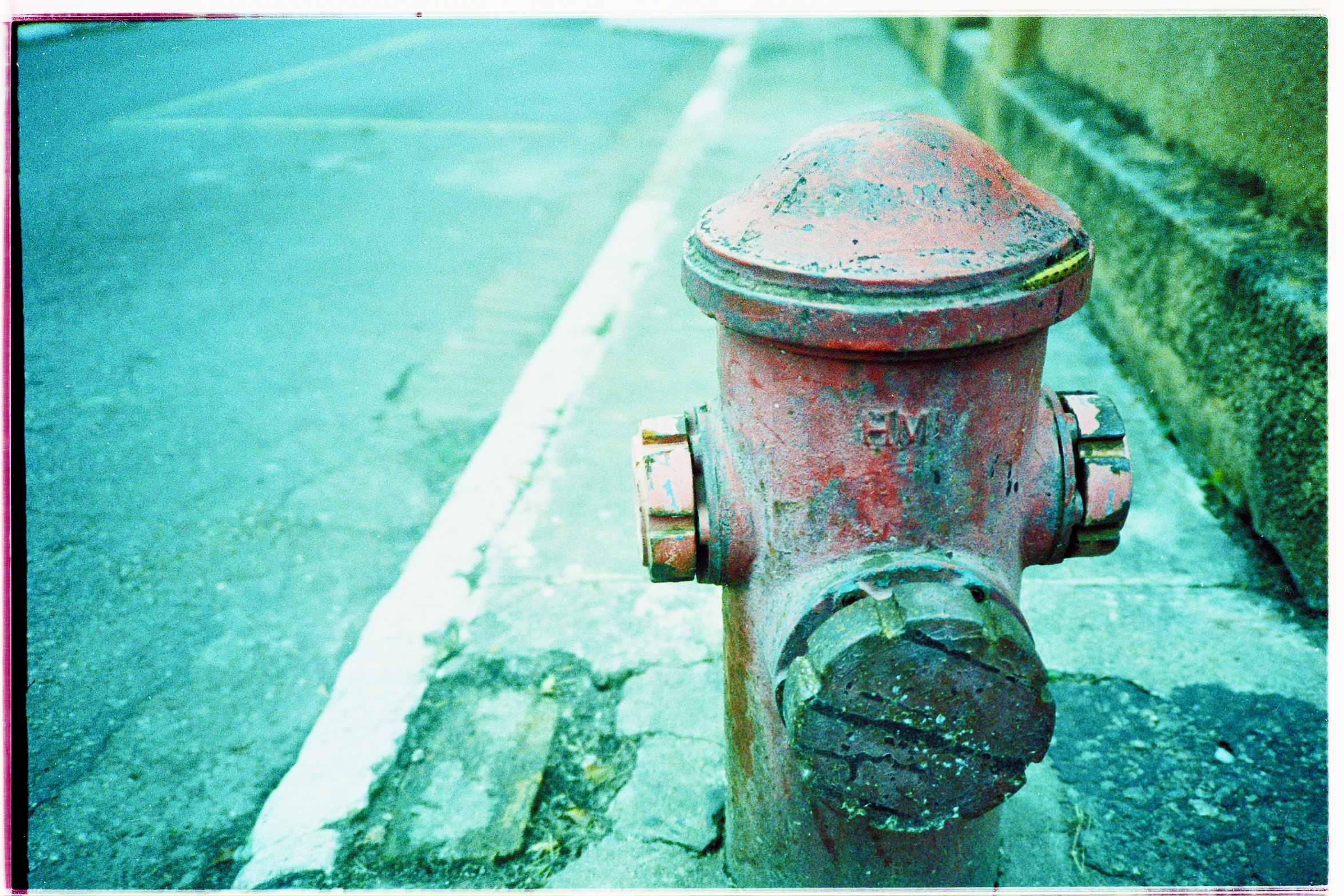 there is a red fire hydrant on the sidewalk