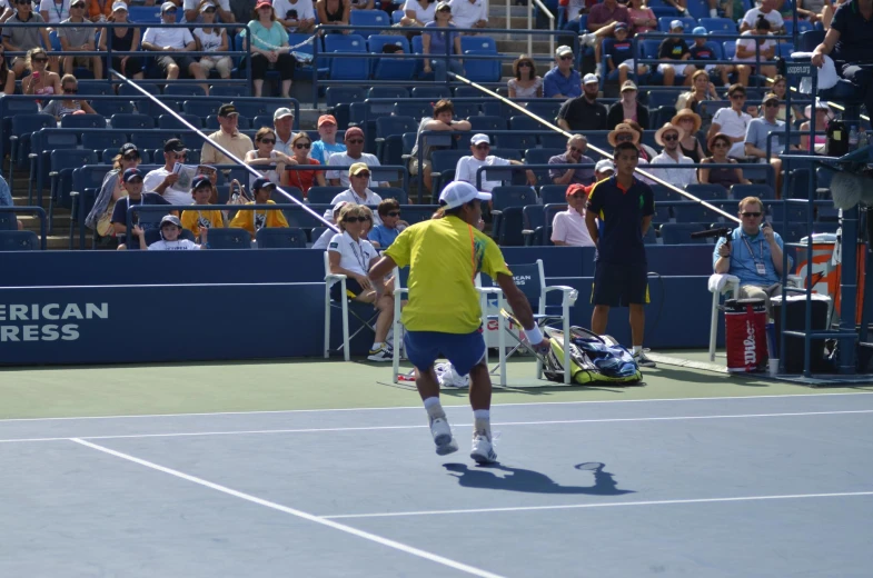 a man standing on top of a tennis court holding a racquet