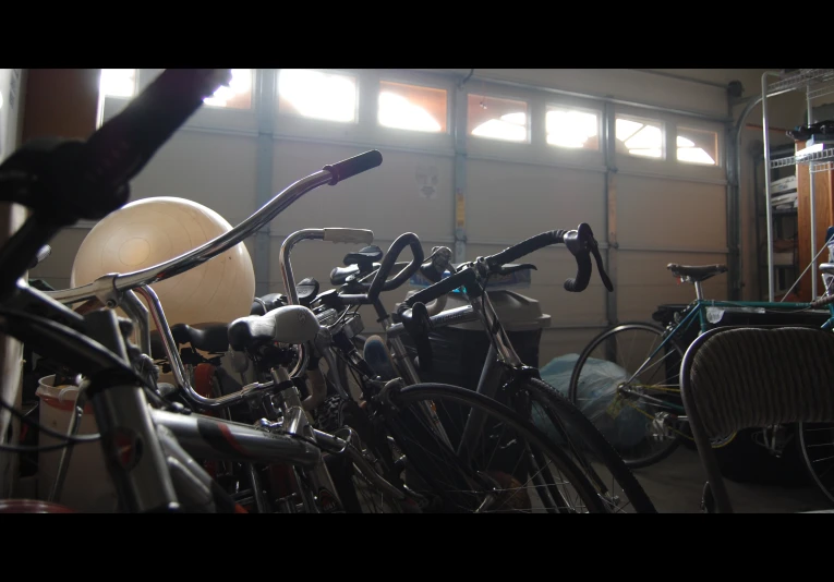 bicycles in garage setting with large open doors