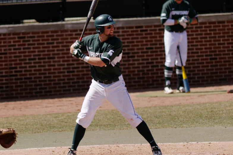 a baseball player holding a bat on top of a field